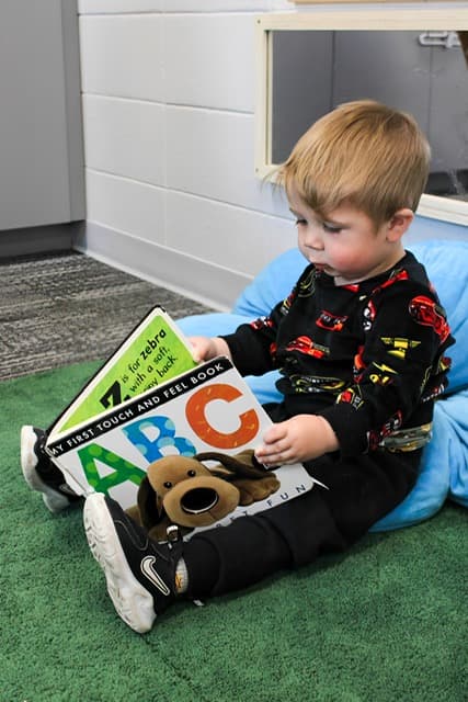 A toddler exploring a picture book